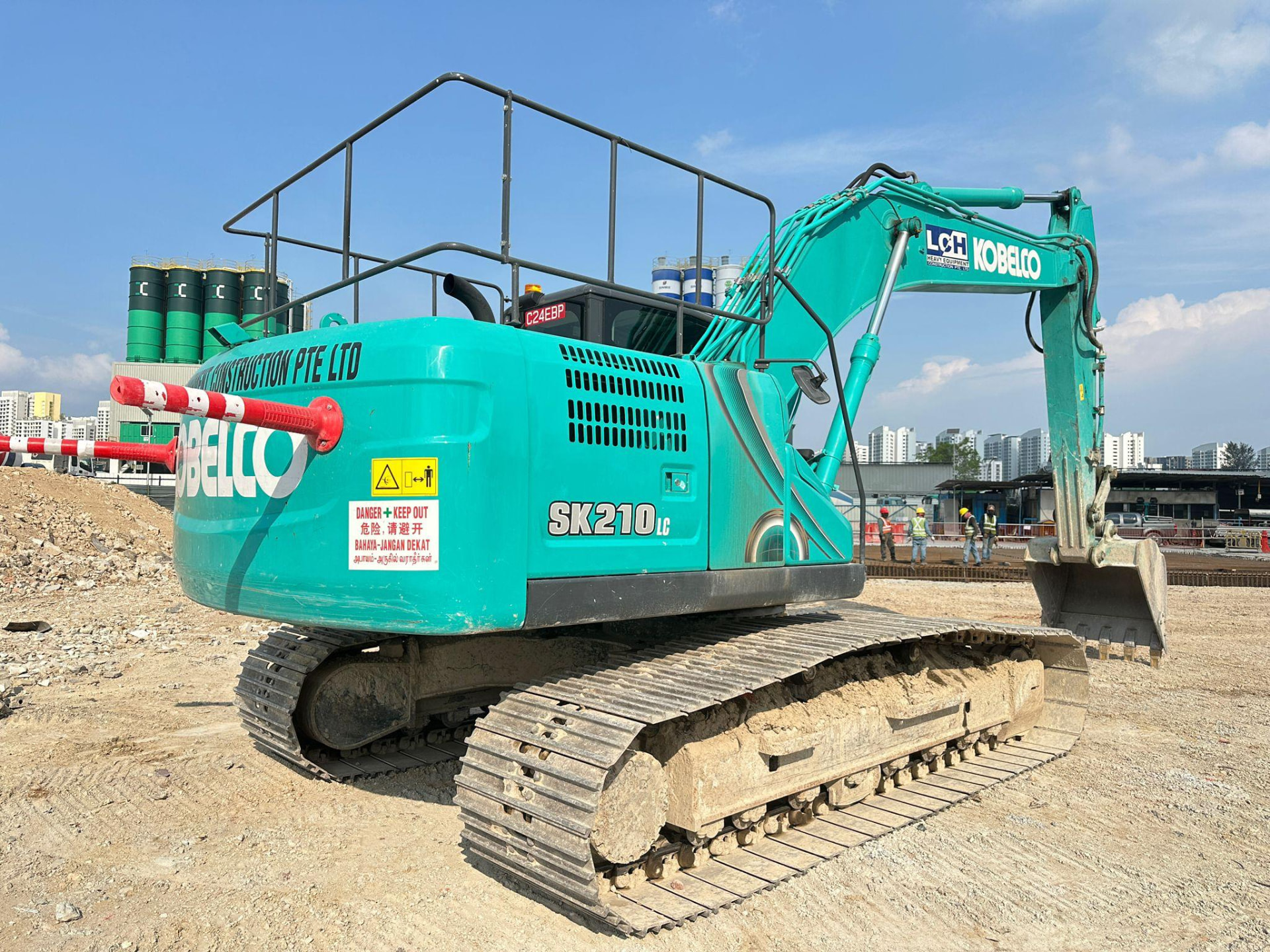 LCH crew operating an excavator on a Singapore drainage and earthworks site